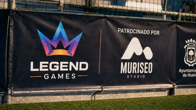 Lona de patrocinio de Legend Games con el logo de Muriseo Studio y el escudo del Ayuntamiento de Huelva
